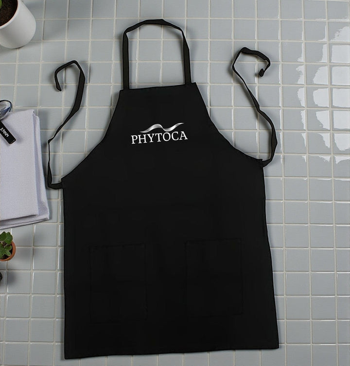 Delantal de peluquería Phytoca USA negro con bolsillos frontales y logo blanco bordado en el pecho